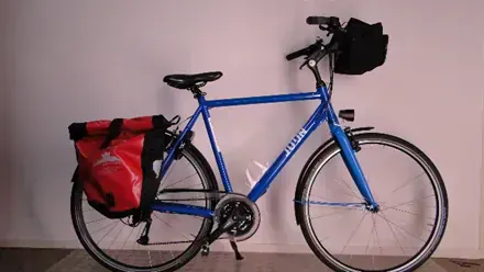 Velo de randonnee bleu avec sacoches rouge et noire - Pays-Bas